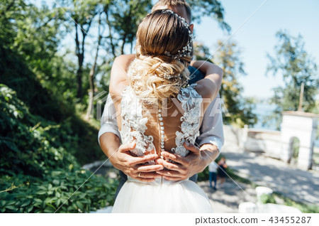 Bride and groom are hugging during the day 43455287