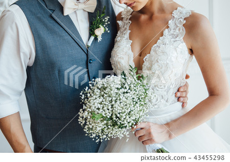 bride and groom together holding wedding bouquet bride and groom together holding wedding bouquet 43455298
