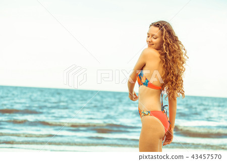 Happy young woman at beach in summer vacation. 43457570