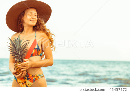 Happy woman wearing swimsuit on beach in summer 43457572