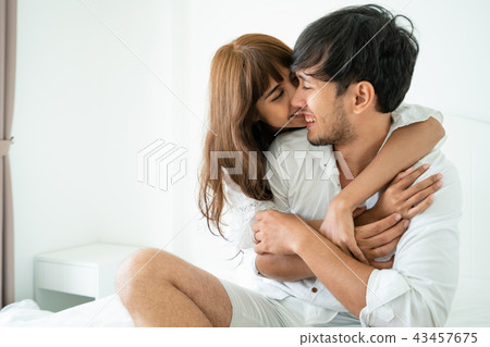 Happy young couple relaxing in the home bedroom. 43457675