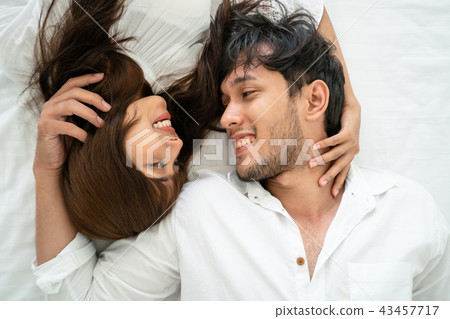 Happy young couple relaxing in the home bedroom. 43457717