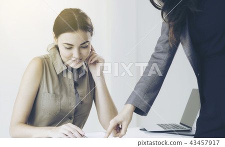 Young employee and manager in meeting at office. 43457917