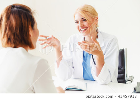 Woman Doctor and Female Patient in Hospital Office Woman Doctor and Female Patient in Hospital Office 43457918