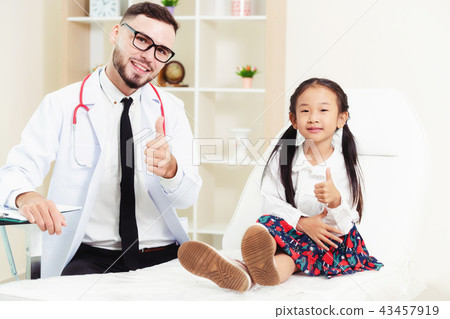 Doctor examining little happy kid in hospital. 43457919