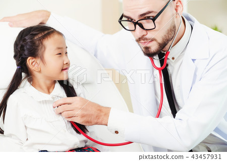 Doctor examining little happy kid in hospital. 43457931