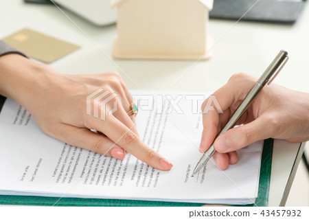 Businesswoman signs agreement contract in office. 43457932