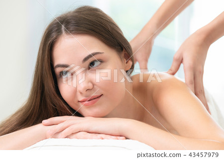 Woman gets back massage spa by massage therapist. 43457979