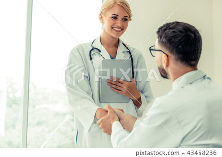 Doctor at hospital shakes hand with another doctor 43458236