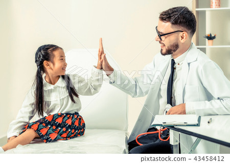 Doctor examining little happy kid in hospital. 43458412