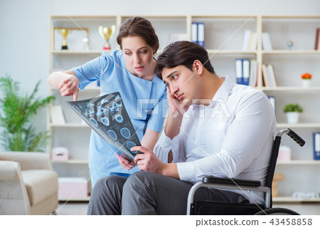 Doctor discussing x-ray image with patient Doctor discussing x-ray image with patient 43458858