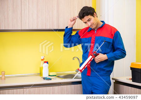 Repairman working in the kitchen  43459097