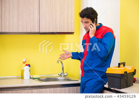 Plumber repairing tap at kitchen 43459129