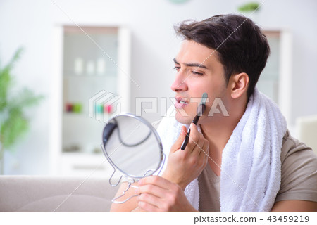 Handsome applying clay mask on face 43459219