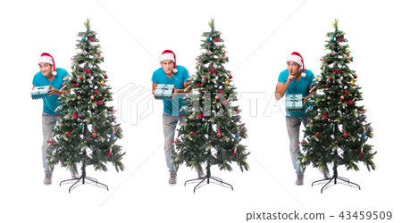 Young man decorating christmas tree isolated on white Young man decorating christmas tree isolated on white 43459509