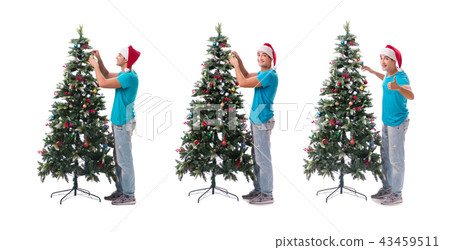 Young man decorating christmas tree isolated on white Young man decorating christmas tree isolated on white 43459511