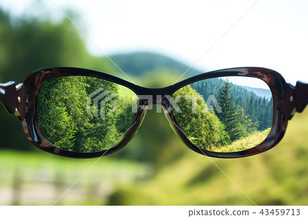 Creative concept about poor vision. Landscape focused in glasses lenses 43459713