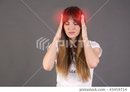 Medical concept about headache. The girl is holding her hands on her temples. 43459714