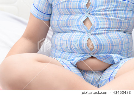 Obese fat boy overweight. Tight shirt of pajamas Obese fat boy overweight. Tight shirt of pajamas 43460488