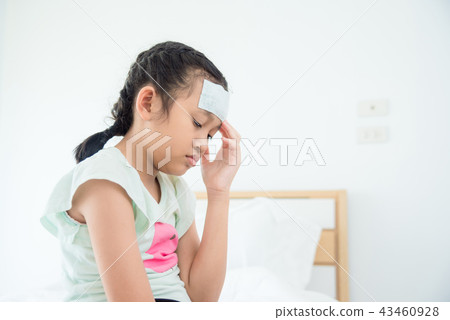 Girl with cool gel on forehead having headache  43460928