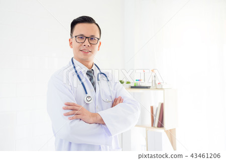 doctor standing in hospital office and smiles doctor standing in hospital office and smiles 43461206