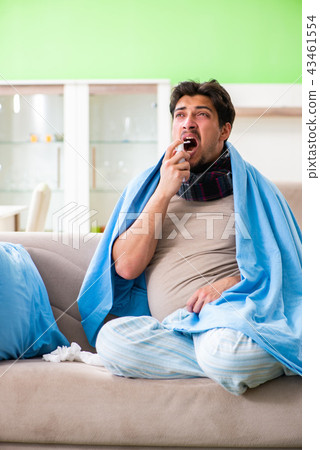 Sick young man suffering from flu at home 43461554