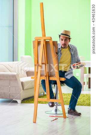 Young male artist working on new painting in his studio 43461630