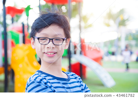 boy standing at playground and smiling at camera 43461782