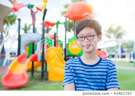 boy standing at playground and smiling at camera boy standing at playground and smiling at camera 43461783