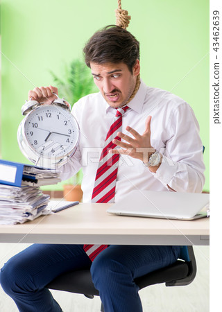 Despaired businessman thinking of suicide in the office  43462639