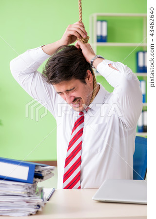 Despaired businessman thinking of suicide in the office Despaired businessman thinking of suicide in the office 43462640