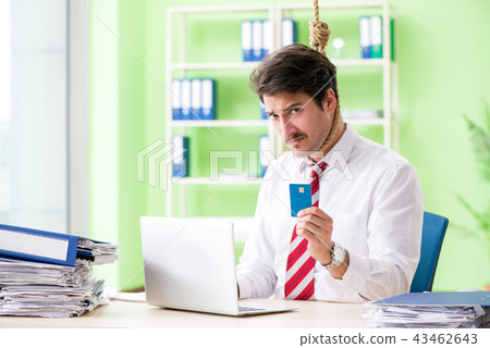 Despaired businessman thinking of suicide in the office Despaired businessman thinking of suicide in the office 43462643