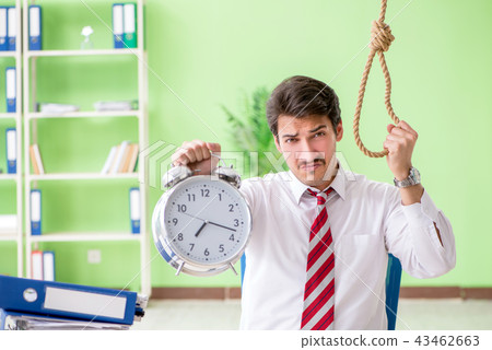 Despaired businessman thinking of suicide in the office  43462663