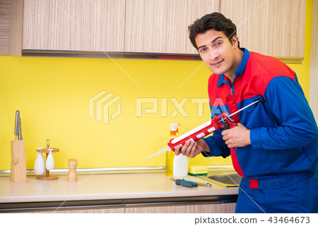 Repairman working in the kitchen Repairman working in the kitchen 43464673