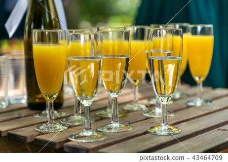 sparkling wine in glasses with orange juice in restaurant or on a party dinner setting 43464709