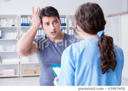 Young man visiting female traumatologist with black eye Young man visiting female traumatologist with black eye 43465408