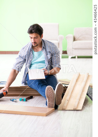 Man laying flooring at home 43466425