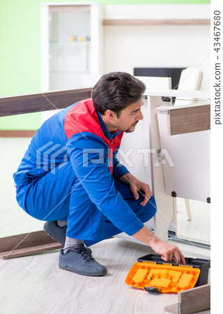 Repair contractor repairing broken furniture at home Repair contractor repairing broken furniture at home 43467680