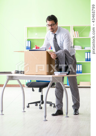 Male employee collecting his stuff after redundancy Male employee collecting his stuff after redundancy 43468799