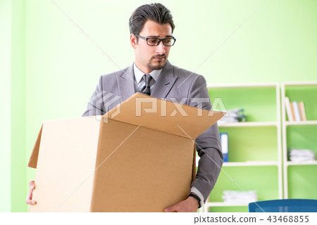 Male employee collecting his stuff after redundancy Male employee collecting his stuff after redundancy 43468855