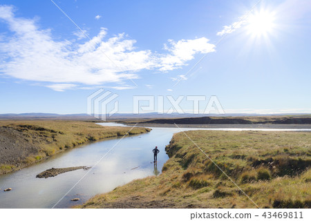 A man tourist enjoy the view of The river Olfusa A man tourist enjoy the view of The river Olfusa 43469811