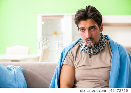 Sick young man suffering from flu at home Sick young man suffering from flu at home 43472756