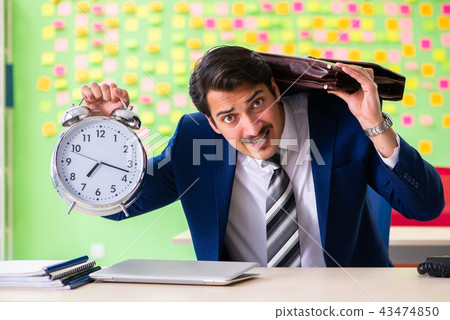 Businessman with many conflicting priorities in time management Businessman with many conflicting priorities in time management 43474850