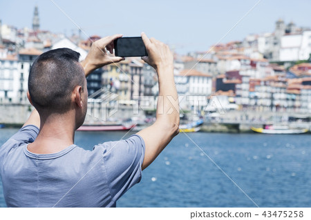 man taking a picture of Porto Cathedral, Portugal 43475258