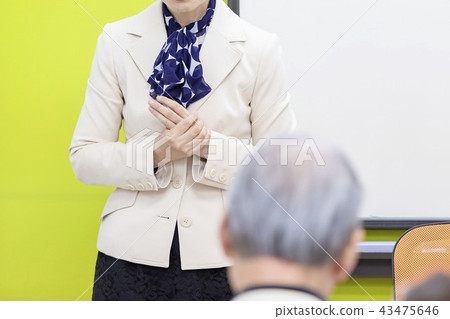A woman talking at a seminar A woman talking at a seminar 43475646