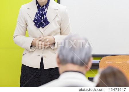 A woman talking at a seminar A woman talking at a seminar 43475647
