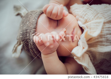 Sleeping baby wearing a hat Sleeping baby wearing a hat 43475818