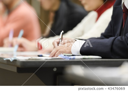 A man taking a note at a seminar 43476069