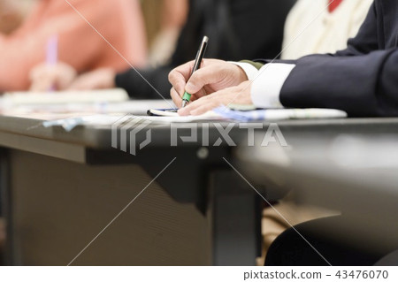 A man taking a note at a seminar 43476070