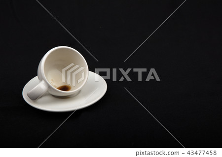 Empty little cup of coffee on the side Empty little cup of coffee on the side 43477458